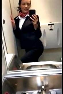 naughty busty stewardess playing with her pussy in restroom